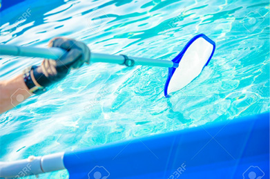 A person lowering a pool cleaning net into the water